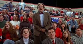 Movie still from “Flubber” (1997), directed by Les Mayfield – A group of people sitting in the stands at a sporting event; Medium shot, Low angle