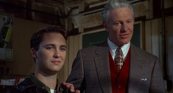 Movie still from “Flubber” (1997), directed by Les Mayfield – A man and a young man standing next to each other; Close Up shot, Over the shoulder angle