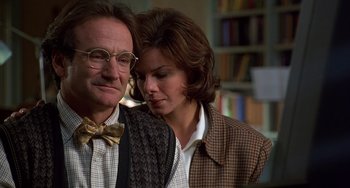 Movie still from “Flubber” (1997), directed by Les Mayfield – A man and a woman standing next to each other in a room; Close Up shot, Over the shoulder angle