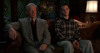 Movie still from “Flubber” (1997), directed by Les Mayfield – A man and a man sitting next to each other on a couch; Medium shot, Low angle