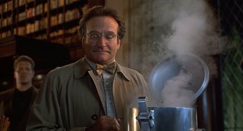 Movie still from “Flubber” (1997), directed by Les Mayfield – A man in a bow tie and glasses is looking at a pot of tea; Medium shot, Low angle