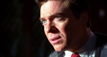 Movie still from “Flubber” (1997), directed by Les Mayfield – A person wearing a suit and tie; Close Up shot, Low angle