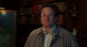 Movie still from “Flubber” (1997), directed by Les Mayfield – A person wearing glasses and a bow tie; Close Up shot, Low angle