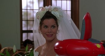 Movie still from “Flubber” (1997), directed by Les Mayfield – A woman in a wedding dress and veil with a red telephone; Close Up shot, High angle
