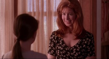 Movie still from “Fly Away Home” (1996), directed by Carroll Ballard – A woman with red hair is smiling for the camera; Close Up shot, Over the shoulder angle