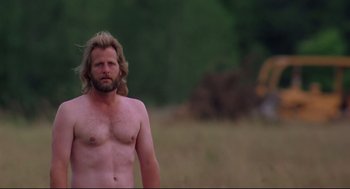 Movie still from “Fly Away Home” (1996), directed by Carroll Ballard – A man with long blond hair stands in a field; Medium shot, Low angle