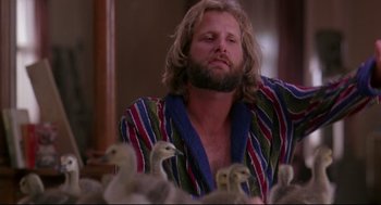 Movie still from “Fly Away Home” (1996), directed by Carroll Ballard – A man with a beard is surrounded by ducks; Medium shot, Low angle