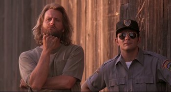 Movie still from “Fly Away Home” (1996), directed by Carroll Ballard – A man with a beard standing next to a man in a uniform; Medium shot, Low angle