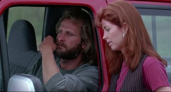 Movie still from “Fly Away Home” (1996), directed by Carroll Ballard – A man and a woman sitting in the back of a red car; Close Up shot, Low angle