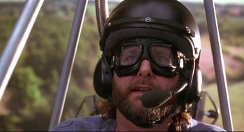Movie still from “Fly Away Home” (1996), directed by Carroll Ballard – A man wearing a helmet and goggles while sitting in a helicopter; Close Up shot, Low angle