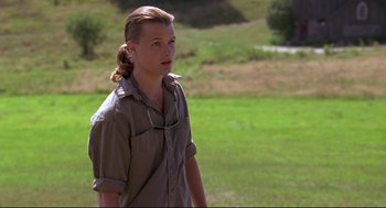 Movie still from “Fly Away Home” (1996), directed by Carroll Ballard – A man in a field wearing a brown shirt; Close Up shot, Over the shoulder angle