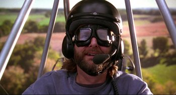 Movie still from “Fly Away Home” (1996), directed by Carroll Ballard – A man wearing a helmet and goggles while sitting in a helicopter; Close Up shot, Low angle