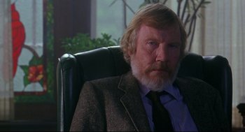 Movie still from “Fly Away Home” (1996), directed by Carroll Ballard – An older man sitting in a chair wearing a suit; Close Up shot, Over the shoulder angle