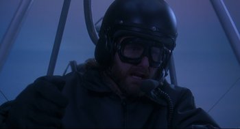 Movie still from “Fly Away Home” (1996), directed by Carroll Ballard – A man wearing a helmet while sitting in an airplane; Close Up shot, Low angle