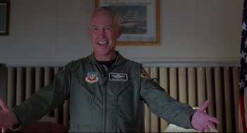 Movie still from “Fly Away Home” (1996), directed by Carroll Ballard – An older man in a military uniform is smiling; Medium shot, Low angle