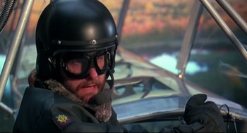 Movie still from “Fly Away Home” (1996), directed by Carroll Ballard – A man wearing a helmet and goggles sitting in an airplane cockpit; Close Up shot, Low angle