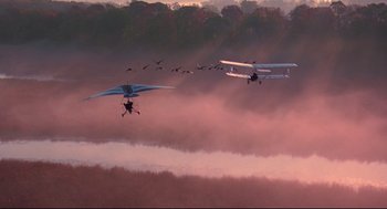 Movie still from “Fly Away Home” (1996), directed by Carroll Ballard – A flock of birds flying over a body of water; Extreme Wide shot, Low angle