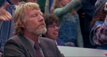 Movie still from “Fly Away Home” (1996), directed by Carroll Ballard – An older man with a beard and glasses sitting next to a woman; Close Up shot, Low angle