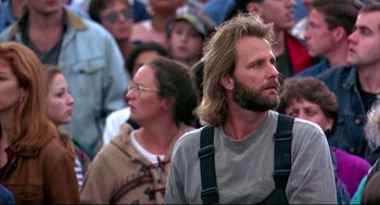 Movie still from “Fly Away Home” (1996), directed by Carroll Ballard – A man with long blond hair is standing next to a woman; Medium shot, Low angle