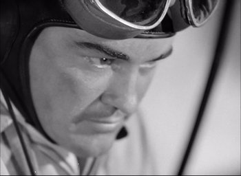 Movie still from “Flying Tigers” (1942), directed by David Miller – Black and white photograph of a man wearing goggles; Close Up shot, Low angle