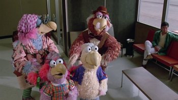 Movie still from “Follow That Bird” (1985), directed by Ken Kwapis – A group of stuffed animals are lined up in a room; Wide shot, High angle