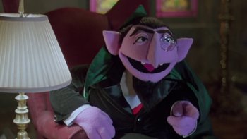 Movie still from “Follow That Bird” (1985), directed by Ken Kwapis – A stuffed animal dressed as the count from sesame street; Medium shot, Low angle