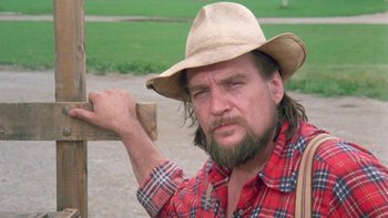 Movie still from “Follow That Bird” (1985), directed by Ken Kwapis – A man with a beard wearing a cowboy hat; Close Up shot, Low angle