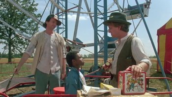 Movie still from “Follow That Bird” (1985), directed by Ken Kwapis – A group of men standing next to each other on a field; Medium shot, Low angle
