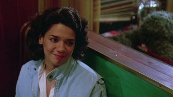 Movie still from “Follow That Bird” (1985), directed by Ken Kwapis – A woman sitting on top of a wooden bench; Close Up shot, High angle