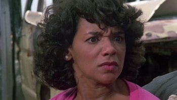 Movie still from “Follow That Bird” (1985), directed by Ken Kwapis – A person with curly black hair; Close Up shot, Low angle
