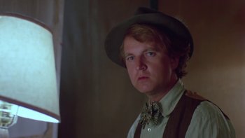 Movie still from “Follow That Bird” (1985), directed by Ken Kwapis – A man wearing a hat and a bow tie; Close Up shot, Low angle