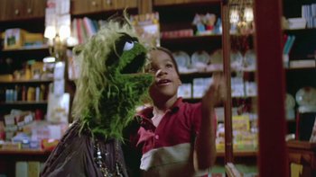 Movie still from “Follow That Bird” (1985), directed by Ken Kwapis – A child is looking at a green monster; Close Up shot, Low angle