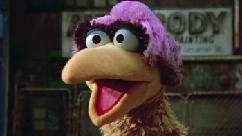 Movie still from “Follow That Bird” (1985), directed by Ken Kwapis – The head and beak of a stuffed bird; Close Up shot, Low angle