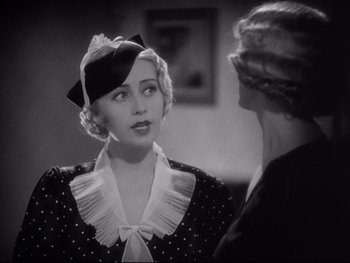Movie still from “Footlight Parade” (1933), directed by Lloyd Bacon – A woman in a polka dot dress talking to another woman; Close Up shot, Over the shoulder angle