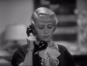 Movie still from “Footlight Parade” (1933), directed by Lloyd Bacon – A woman talking on a phone while holding it to her ear; Close Up shot, High angle