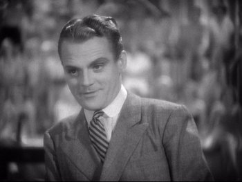 Movie still from “Footlight Parade” (1933), directed by Lloyd Bacon – An old photo of a man in a suit; Close Up shot, High angle