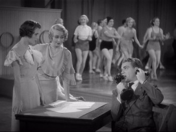 Movie still from “Footlight Parade” (1933), directed by Lloyd Bacon – An old photo of a man talking on the phone; Medium shot, High angle
