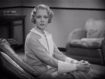 Movie still from “Footlight Parade” (1933), directed by Lloyd Bacon – An old photo of a woman sitting in a chair; Medium shot, High angle