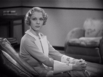 Movie still from “Footlight Parade” (1933), directed by Lloyd Bacon – An old photo of a woman sitting in a chair; Medium shot, Low angle