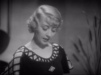 Movie still from “Footlight Parade” (1933), directed by Lloyd Bacon – A black and white photo of a woman in a black dress; Close Up shot, High angle