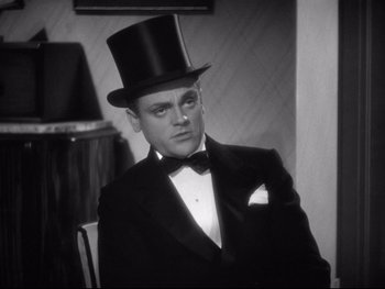 Movie still from “Footlight Parade” (1933), directed by Lloyd Bacon – A man wearing a top hat and a tuxedo; Close Up shot, Low angle
