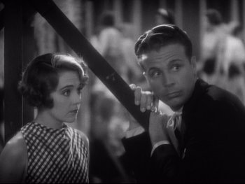 Movie still from “Footlight Parade” (1933), directed by Lloyd Bacon – A man and a woman standing next to each other; Close Up shot, Low angle