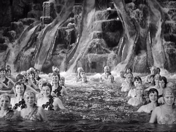 Movie still from “Footlight Parade” (1933), directed by Lloyd Bacon – A black and white photo of a group of people in water; Extreme Wide shot, High angle