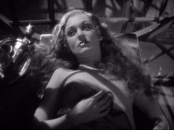 Movie still from “Footlight Parade” (1933), directed by Lloyd Bacon – A black and white photo of a woman with long hair; Close Up shot, High angle