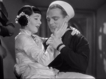 Movie still from “Footlight Parade” (1933), directed by Lloyd Bacon – A man and a woman dancing together in a room; Medium shot, High angle