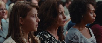 Movie still from “Footloose” (2011), directed by Craig Brewer – A woman and a young girl sitting next to each other in a crowd; Close Up shot, Over the shoulder angle
