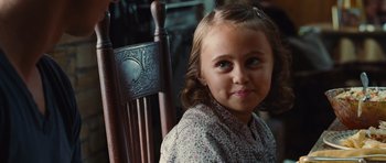 Movie still from “Footloose” (2011), directed by Craig Brewer – A little girl sitting in a chair looking at the camera; Close Up shot, Over the shoulder angle
