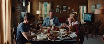 Movie still from “Footloose” (2011), directed by Craig Brewer – A group of people sitting around a table eating food; Wide shot, Over the shoulder angle
