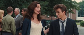 Movie still from “Footloose” (2011), directed by Craig Brewer – A woman standing next to a man in a suit; Close Up shot, Over the shoulder angle