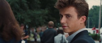 Movie still from “Footloose” (2011), directed by Craig Brewer – A young man's face in front of a group of people; Close Up shot, Over the shoulder angle